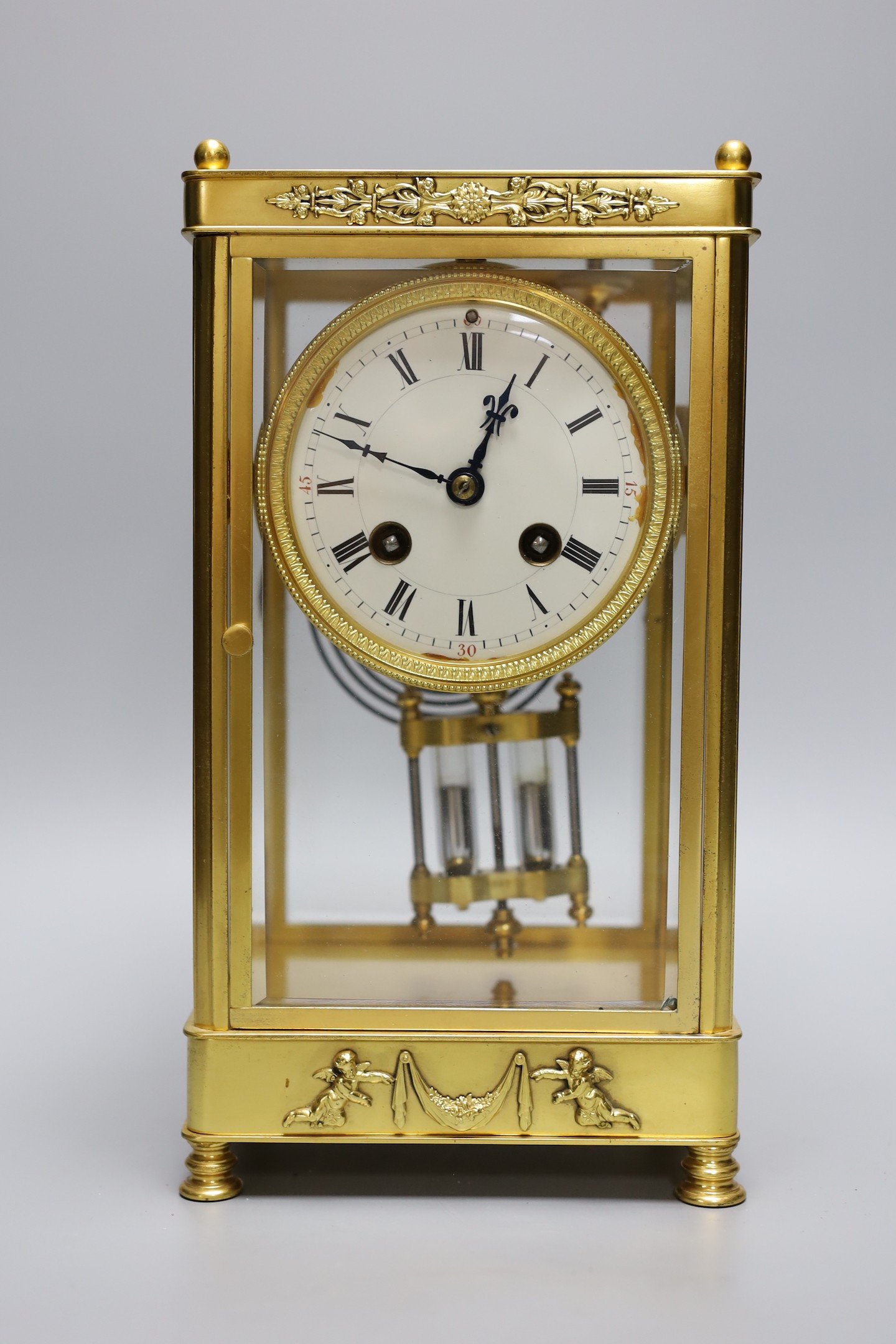 A late 19th century French four glass mantel clock, mercury pendulum and key, 26cm tall